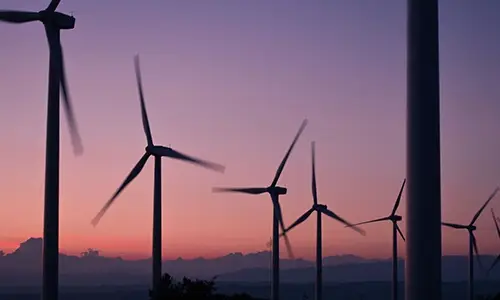 wind turbines with sunset