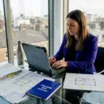 Assessor entering energy data in London office