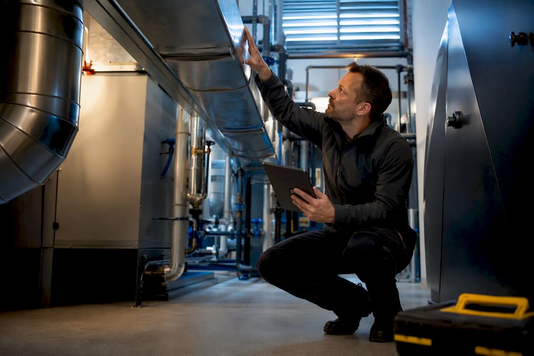 Assessor inspecting commercial building systems