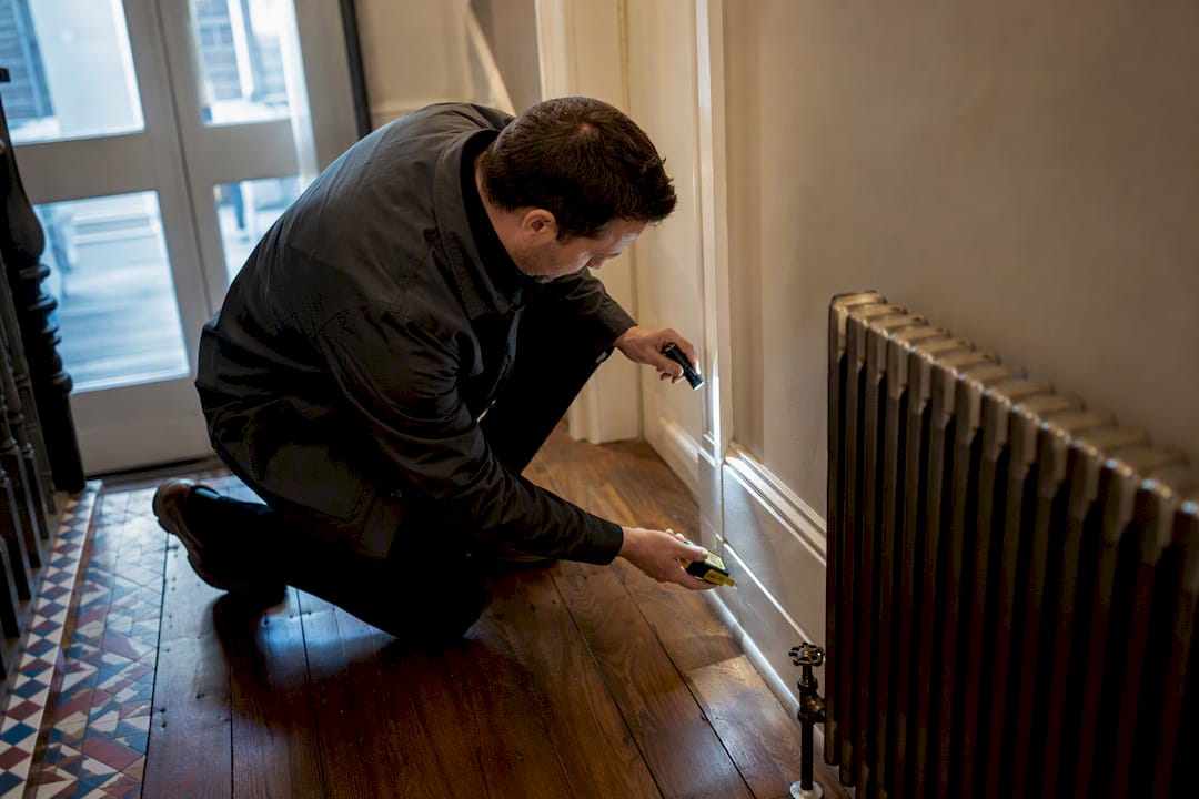 Energy assessor inspecting older London property