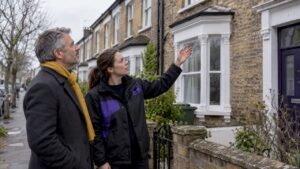 Landlord discussing EPC improvements outside rental property