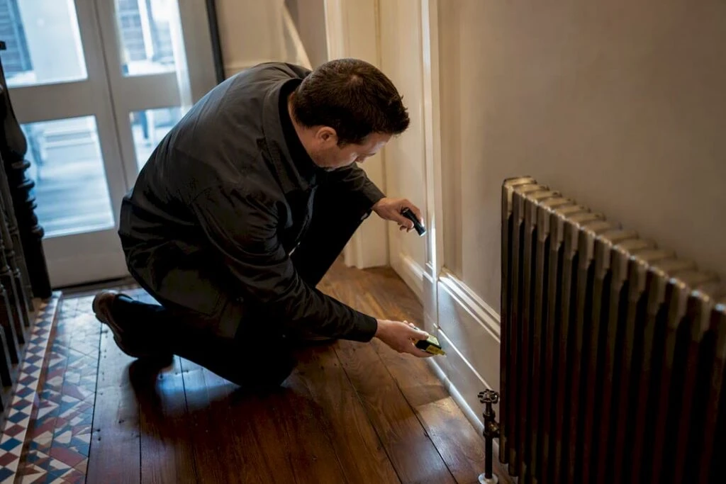 Energy assessor inspecting older London property