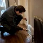 Energy assessor inspecting older London property