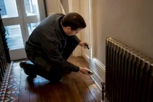 Energy assessor inspecting older London property