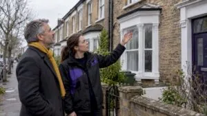Landlord discussing EPC improvements outside rental property