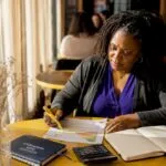 Woman reviewing energy certificate at home table